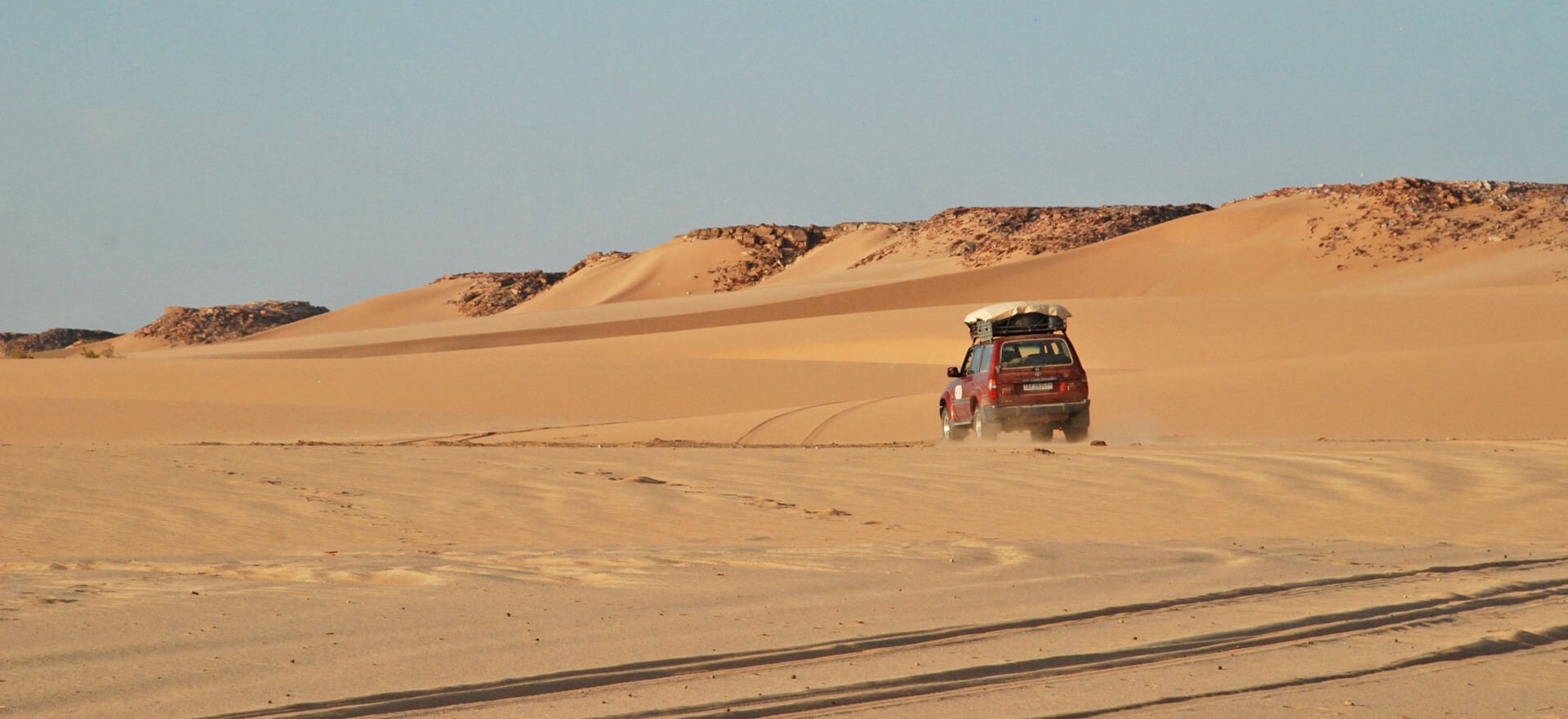 Algeria tours and holidays - driving through desert