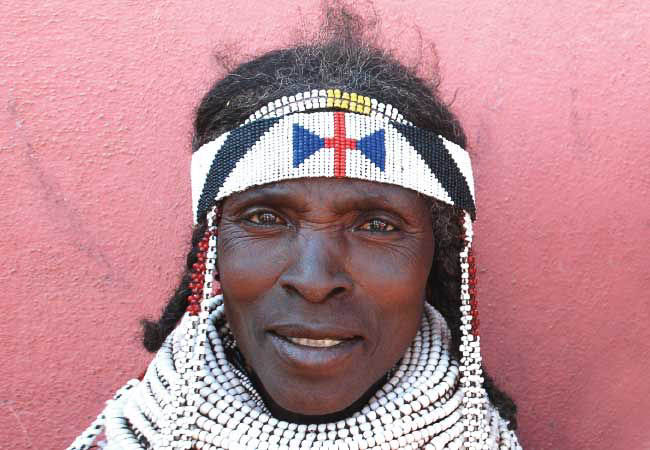 Handa woman with traditional beaded necklace in Hoque market - Angola tours