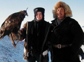 Tourist with golden eagle and hunter - Mongolia tours