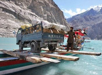 Truck crossing lake in the mountains - Pakistan tours