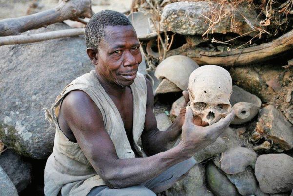 Koma man showing skulls of ancestors - Cameroon tour