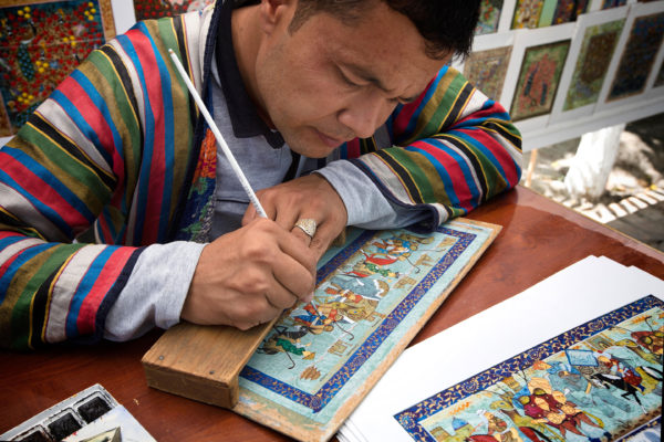 Man making traditional art - Central Asia holidays