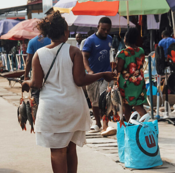 Equatorial Guinea market, woman carrying fish