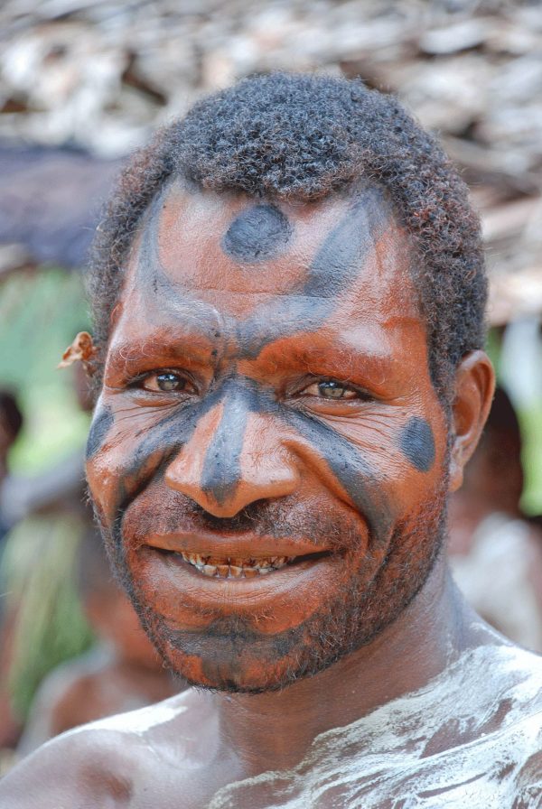 Man with painted face in Sepik River - Papua New Guinea tours