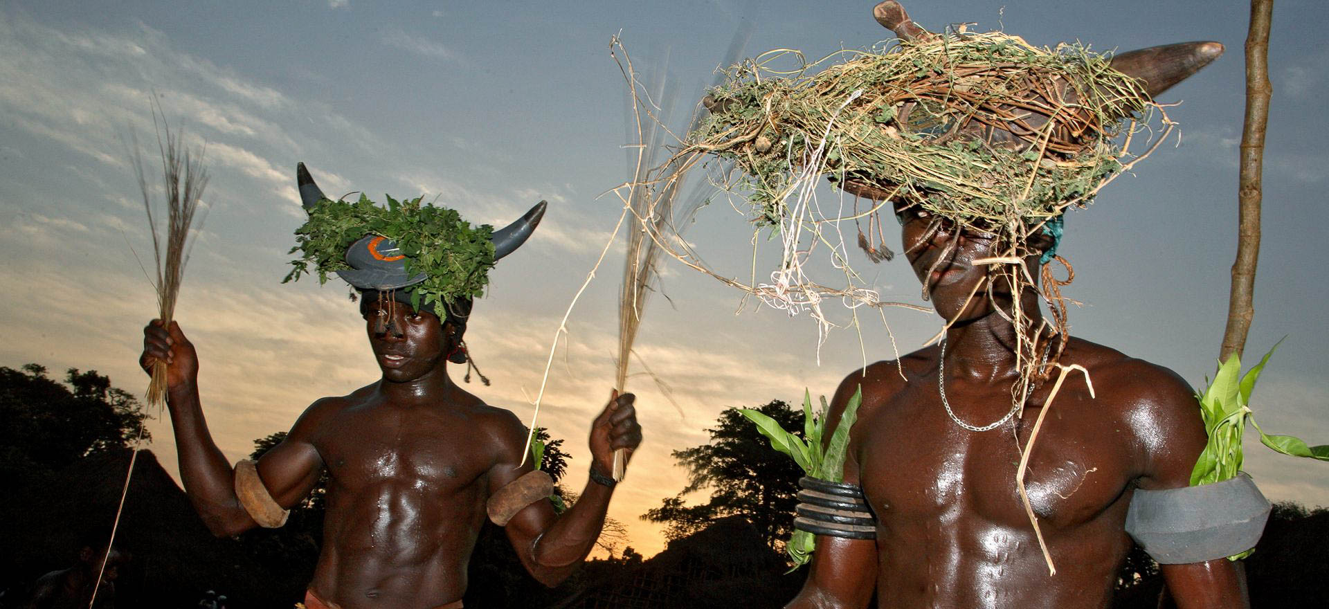 Tribal men dancing in traditional dress - Guinea Bissau Holidays and Tours