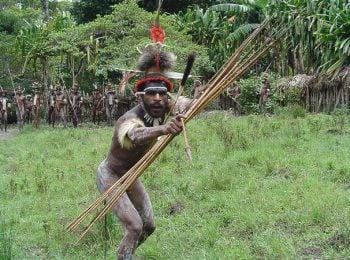 Korowai man in West Papua performing traditional greeting - Indonesia Holidays and Tours