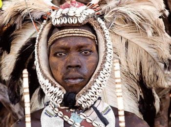 Lotuko man wearing headdress with ostrich feathers - South Sudan Holidays and Tours