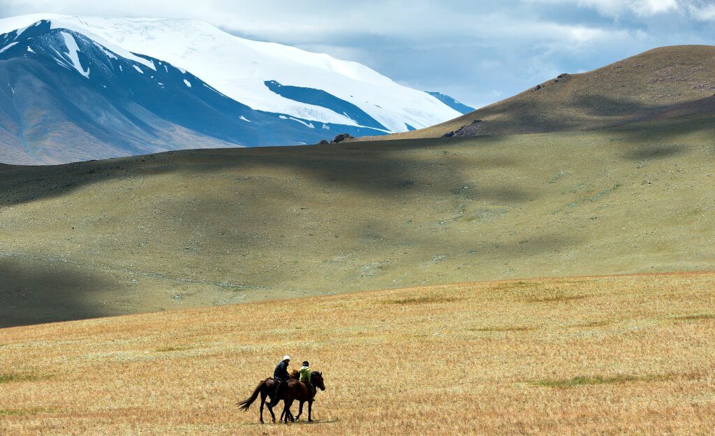 Photo of horse riders in the mountainous Altai landscapes on Central Asia tour