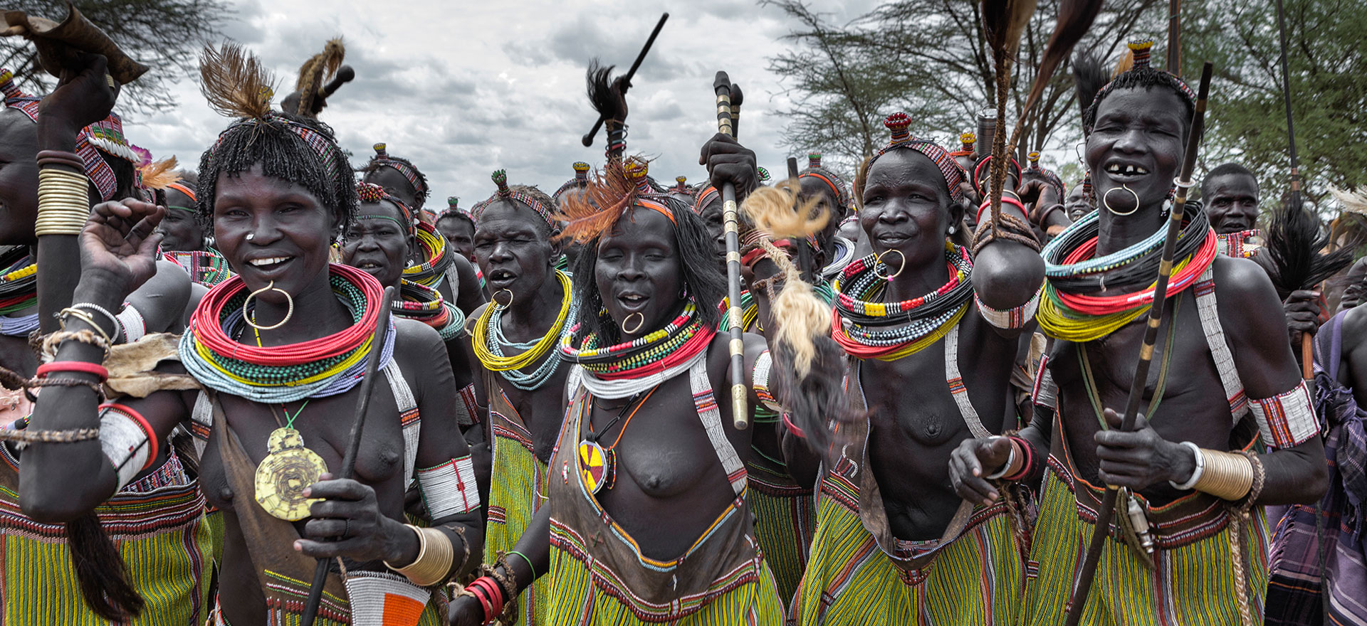 Toposa women in traditional dress dancing - South Sudan Holidays and Tours
