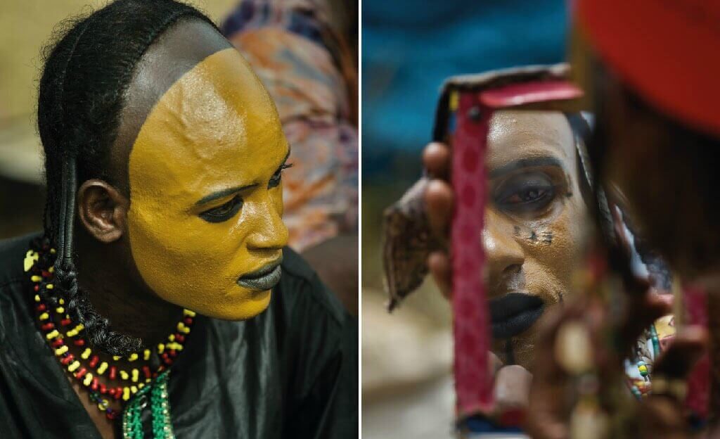 Men applying tradition makeup ahead of the dance