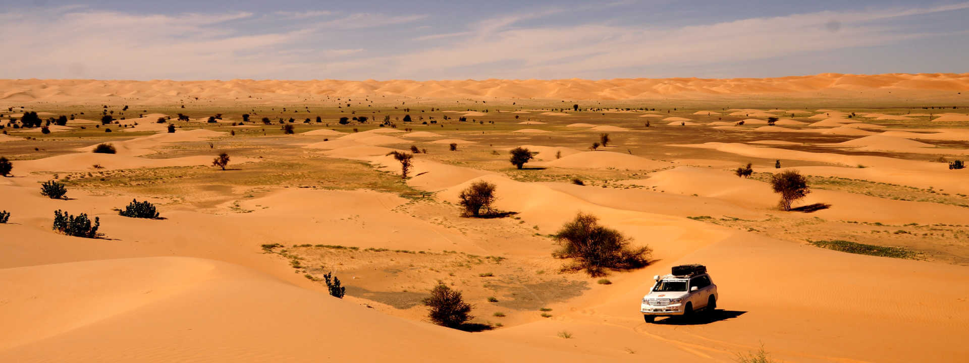 Vehicle on epic journey across the dune in Western Sahara