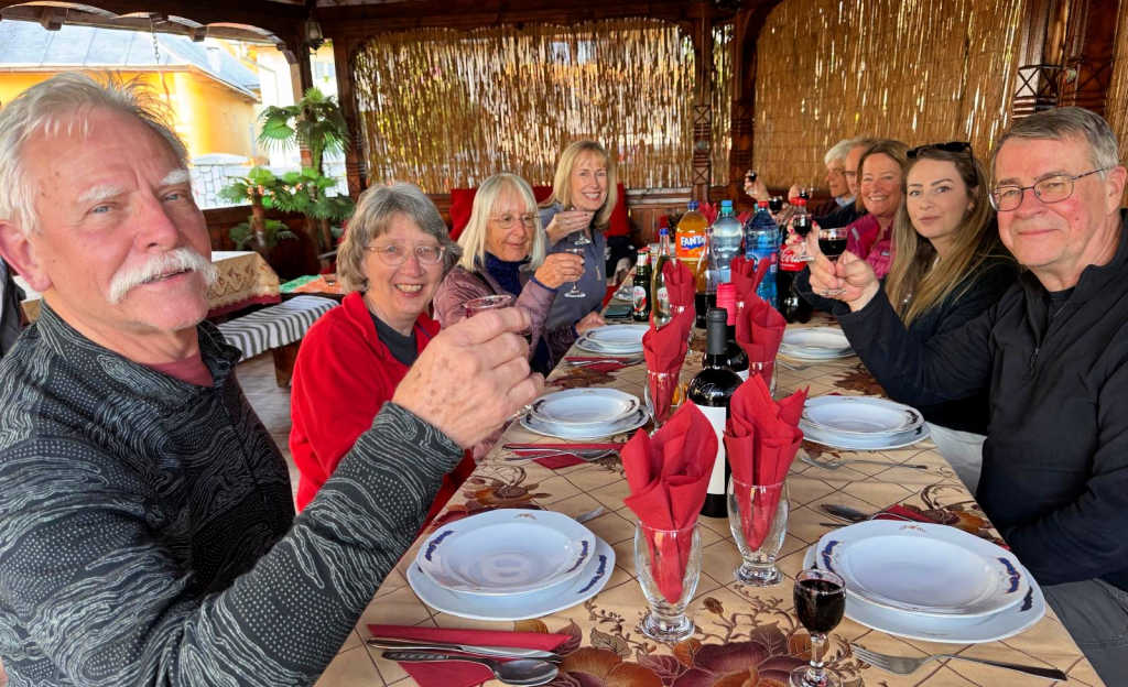 A convivial group tour dinner when visiting Romania with Native Eye