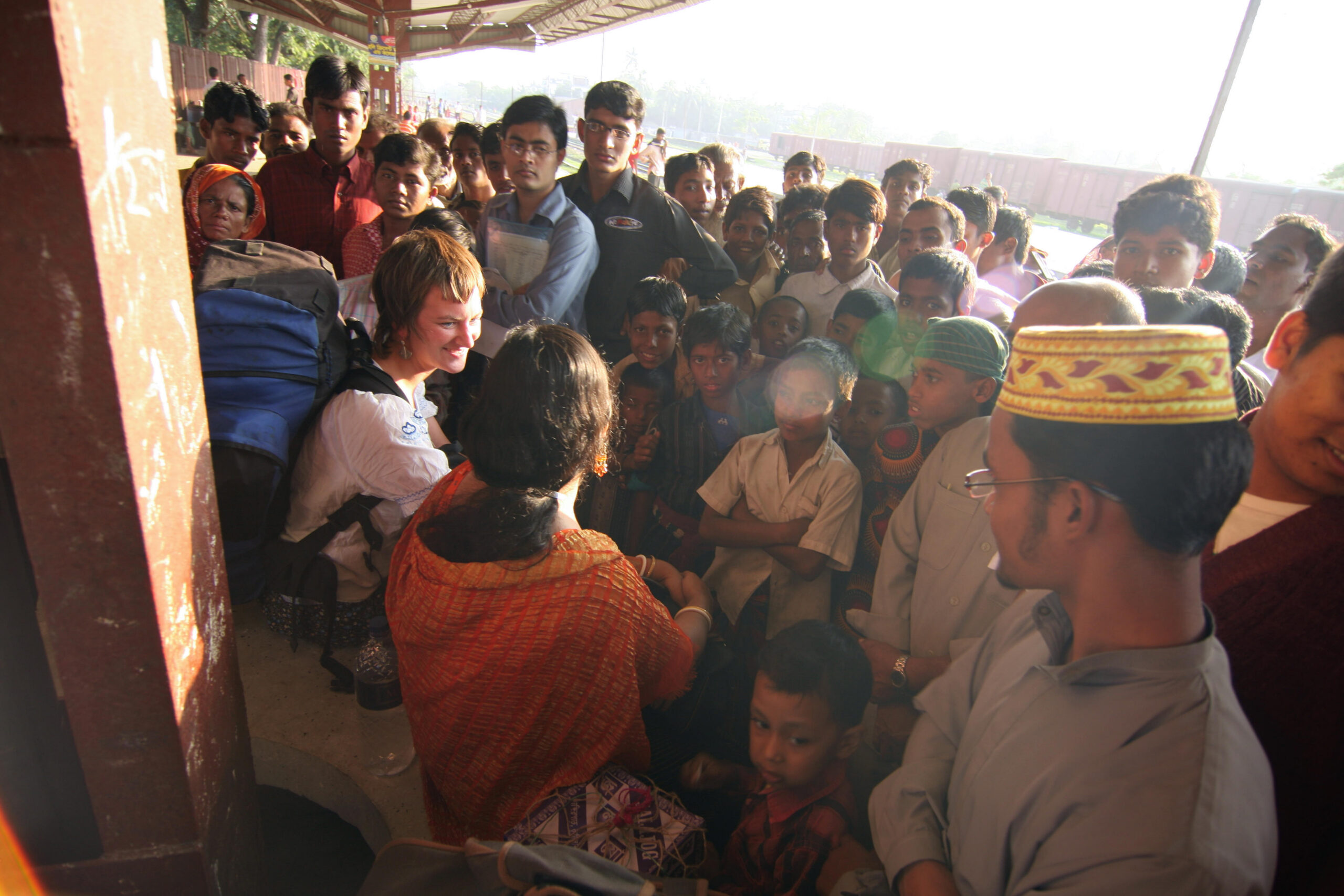 Tourist surrounded by locals, Bangladesh.
